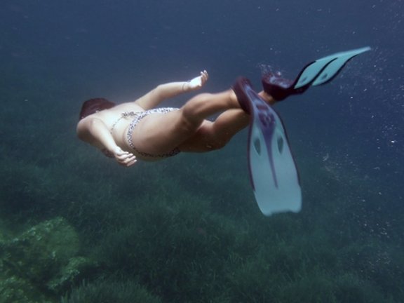 a student is snorkeling under water