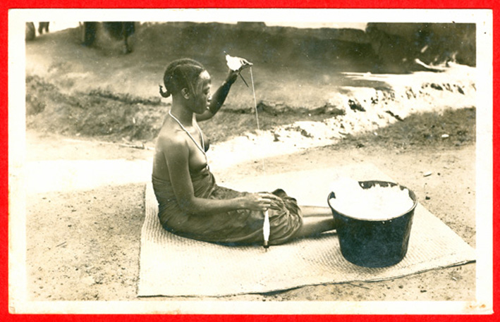 Guinea, woman spinning