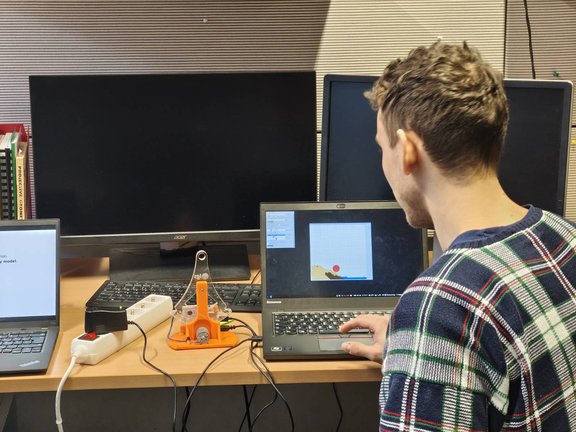 Student testing haptic game Sandbocx