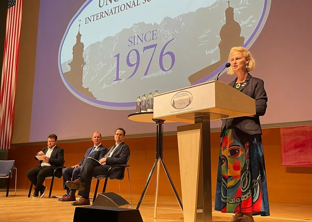 A stage with a podium at which the Rector of the University of Innsbruck stands.