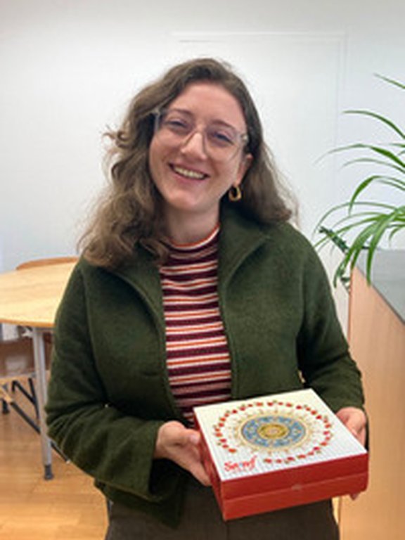 Sevval Kurt holding a box of sweets from Turkey