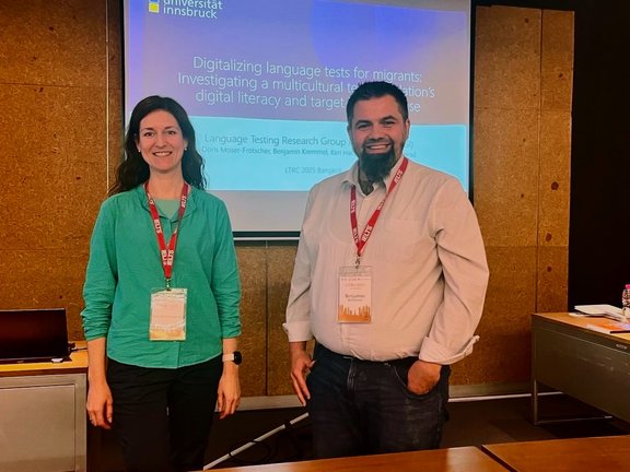 Doris Moser-Frötscher & Benjamin Kremmel in front of screen at LTRC2025