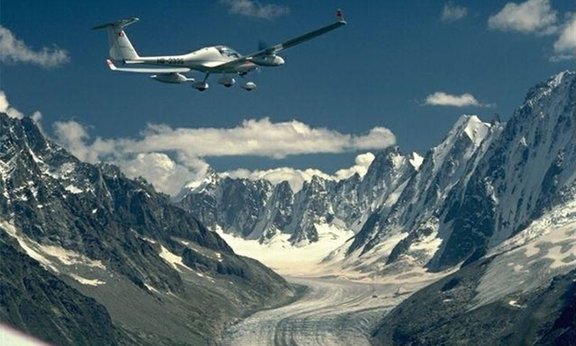 Plane flys through alpine landscape