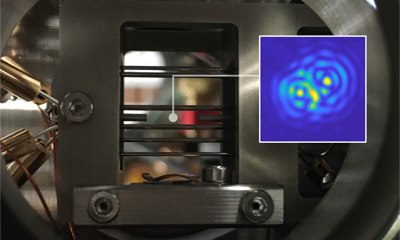 Die Ionenfalle, mit der ein einzelnes Nanoteilchen zum Schweben gebracht wird. Kleines Bild: optische Interferenz zwischen dem Teilchen und seinem Spiegelbild.