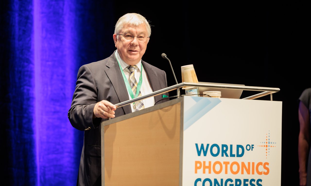 Rainer Blatt at a lectern labeled "World Photonics Conference".