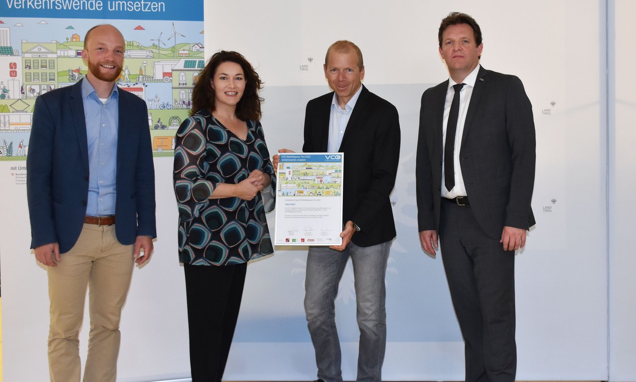 Vier Personen stehen für ein Gruppenfoto zusammen.