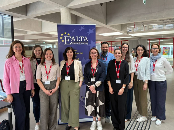 Group photo in front of EALTA banner
