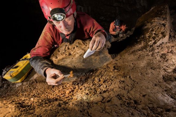 Researcher taking stone samples in the cave