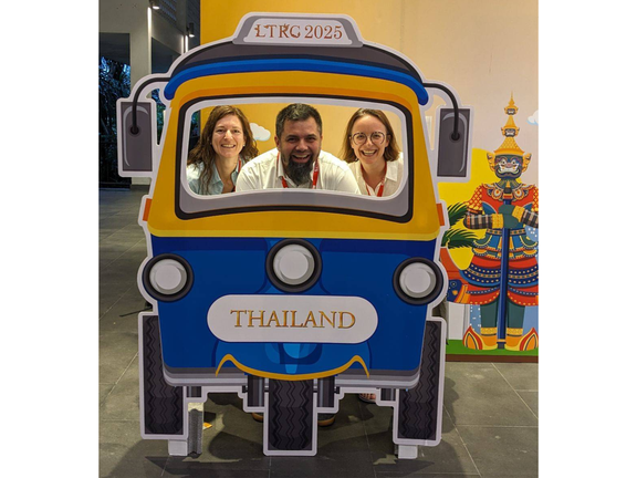 Doris Moser-Frötscher, Benjamin Kremmel & Kathrin Eberharter behind a Tuc-Tuc board