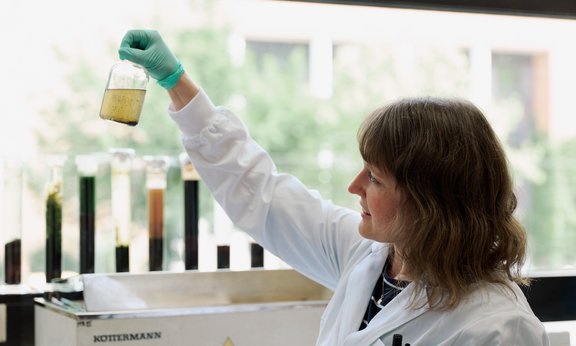 Scientist holding batch reactor