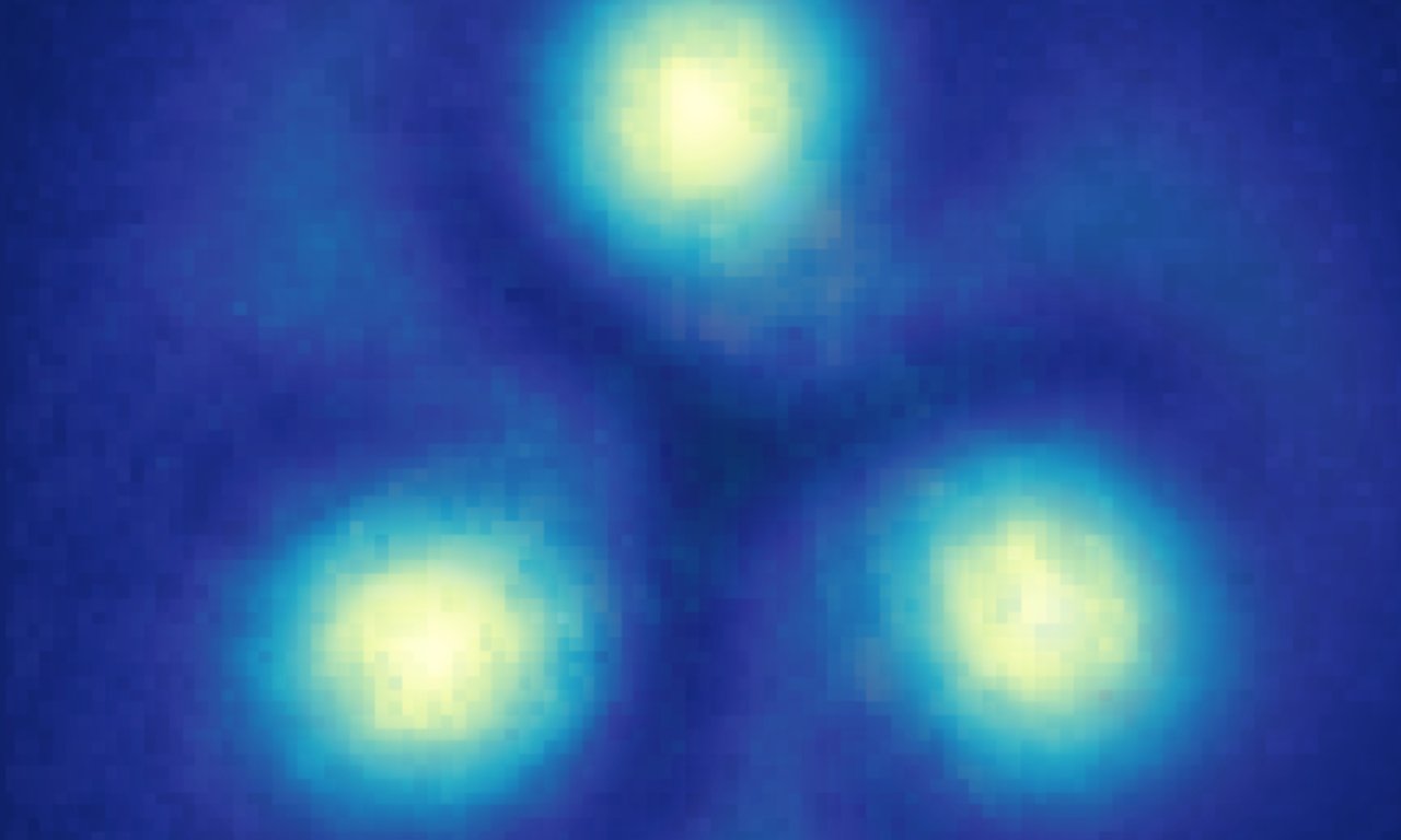 Three yellow dots on a blue background