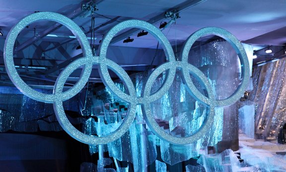 Die olympischen Ringe in blaues Licht getaucht.
