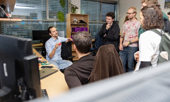 Researcher explaining his work to students