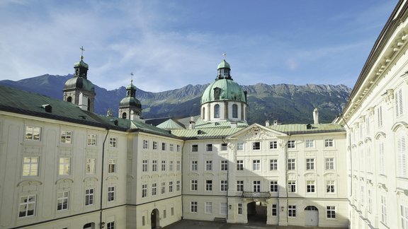 Old castle "Hofburg" with mountains in the background.