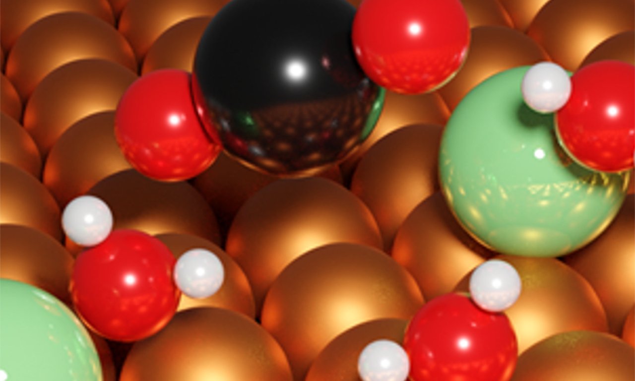 Bunte Kugeln symbolisieren Atome und Moleküle auf einer Oberfläche