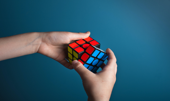 Zwei Hände lösen eine Rubik-Würfel