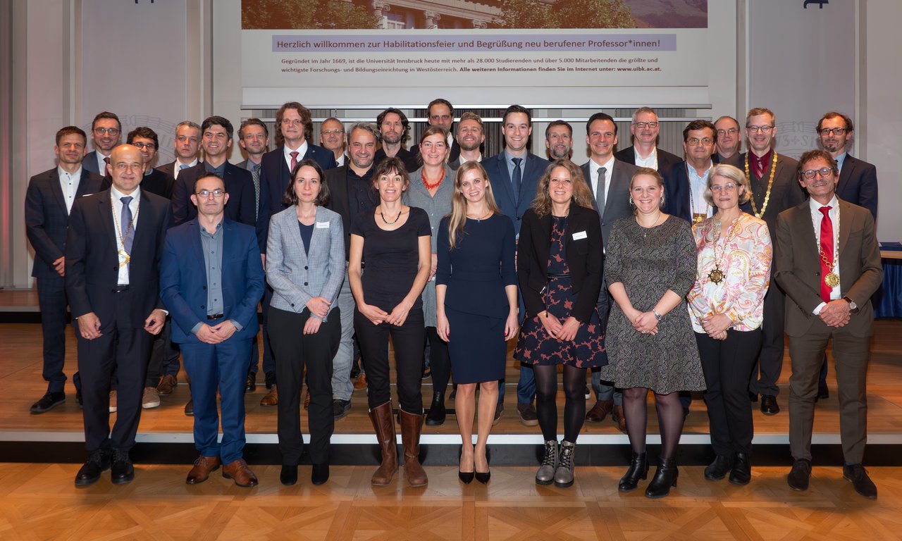 Gruppenbild aller Neuberufenen und Habilitierten mit Dekan:innen und Vizerektor in der Aula – 30 Personen