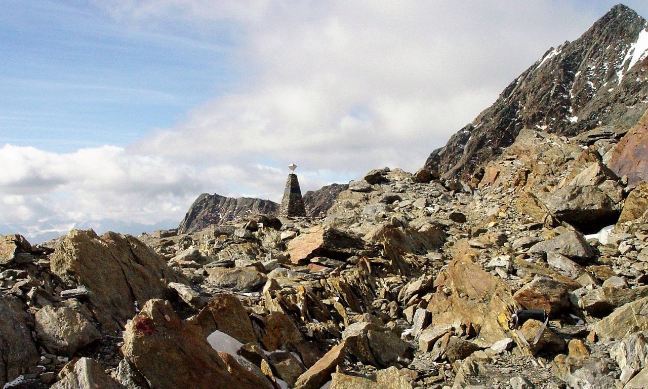 The discovery site of Ötzi on the Tisenjoch with a monument for the ice mummy, view to the south.