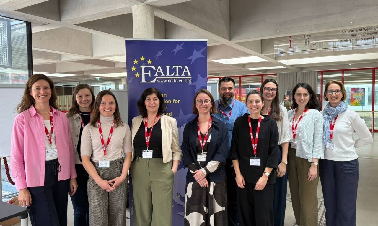 Group photo in front of EALTA banner