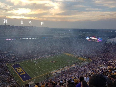 The Mercedes Superdome from above in the evening light, the ranks are full, smoke is rising.