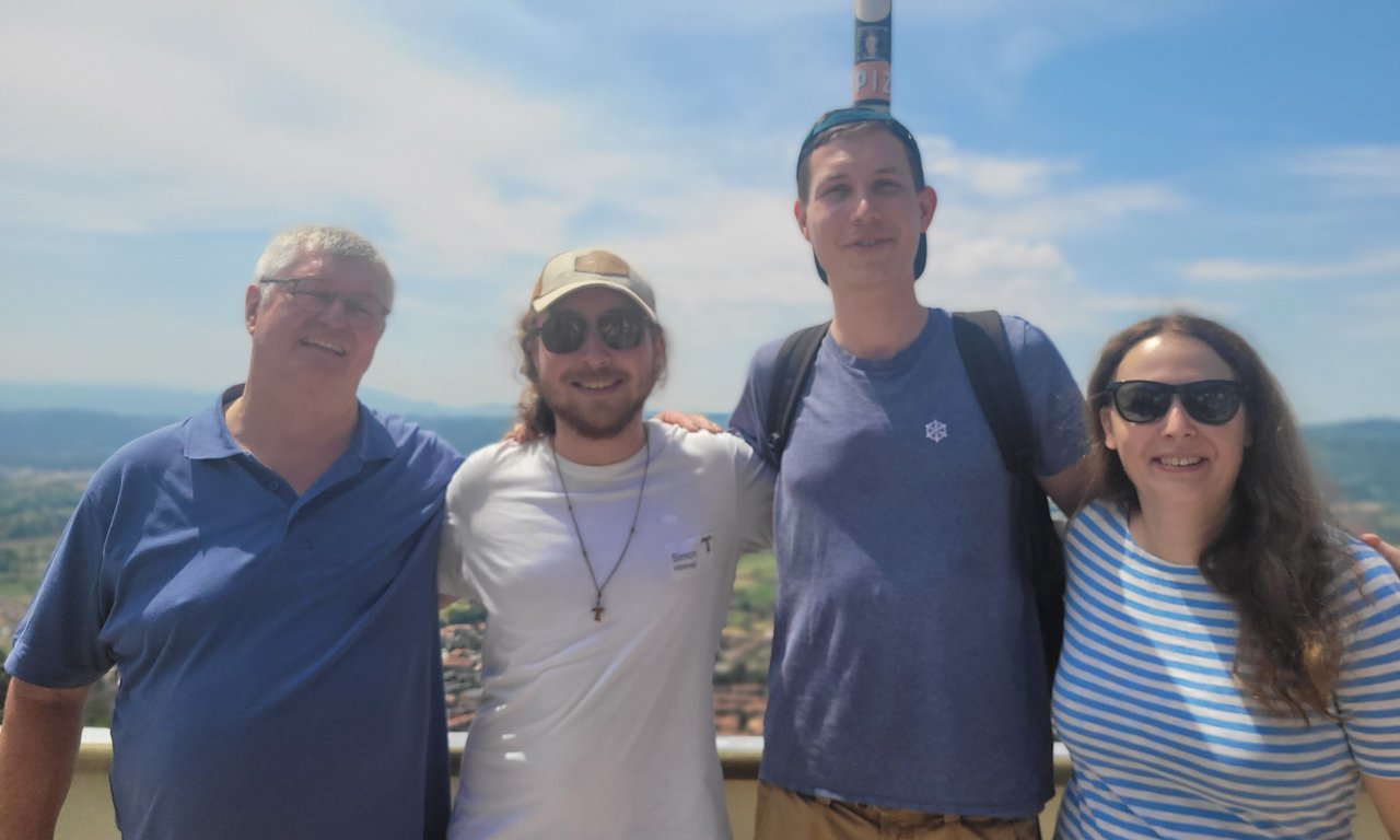 Zu sehen sind Hans Mendl und Studierende der Universität Innsbruck. Sie stehen im Freien.