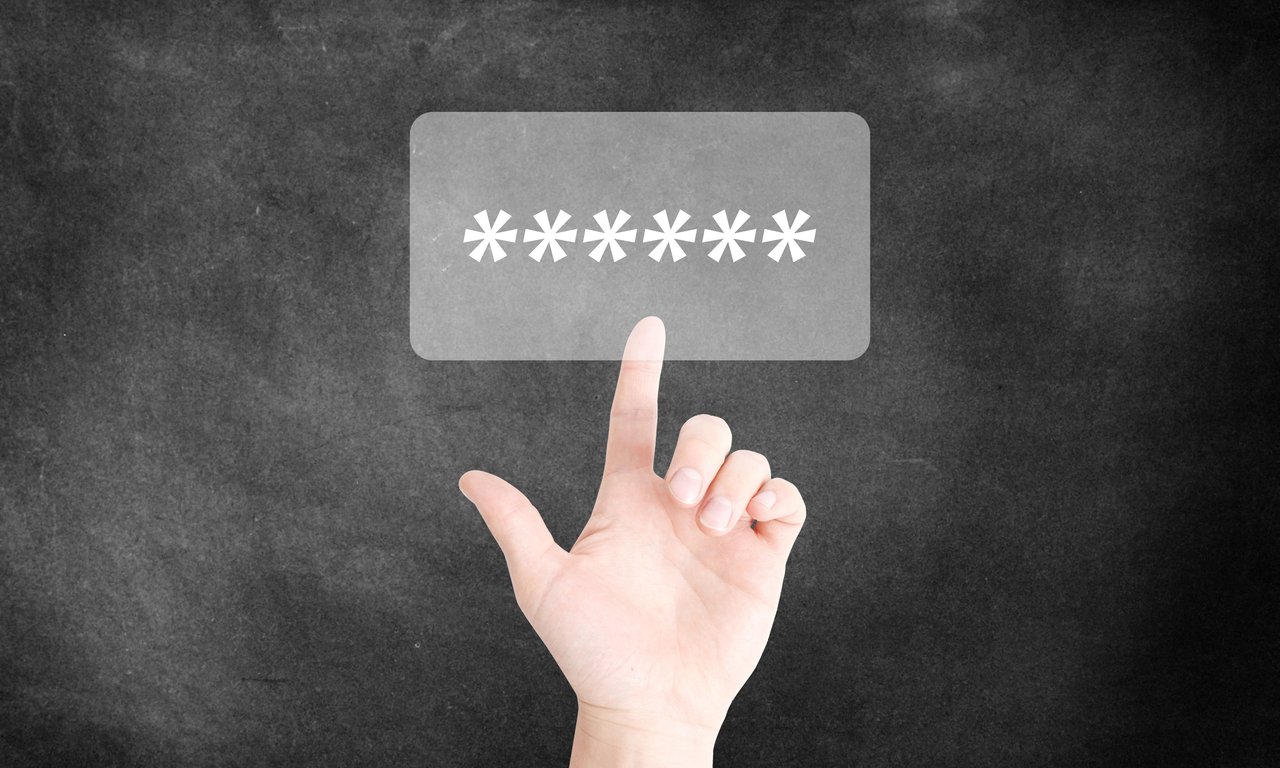 Eine Hand deutet auf ein symbolisiertes Login-Fenster in dem sechs Sterne zu sehen sind.