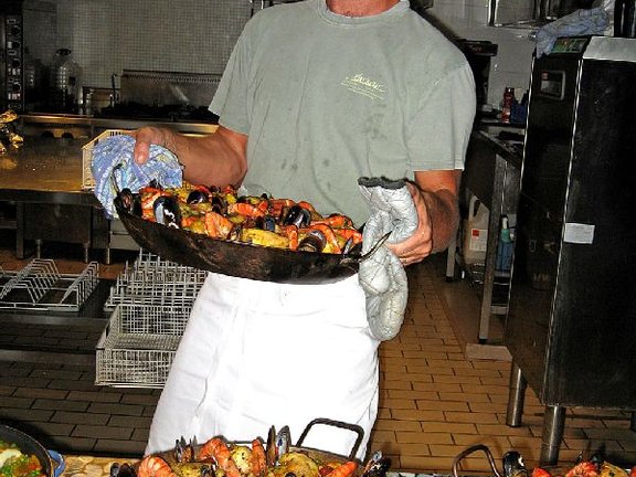 Chef with his fresh ccoked Paella