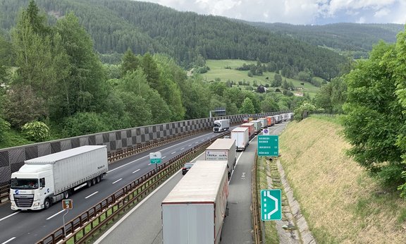 View of a highway with numerous trucks.