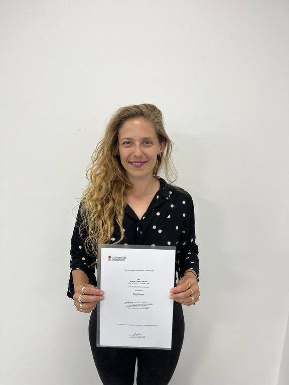 Portrait photo of Marina Eckert with certificate