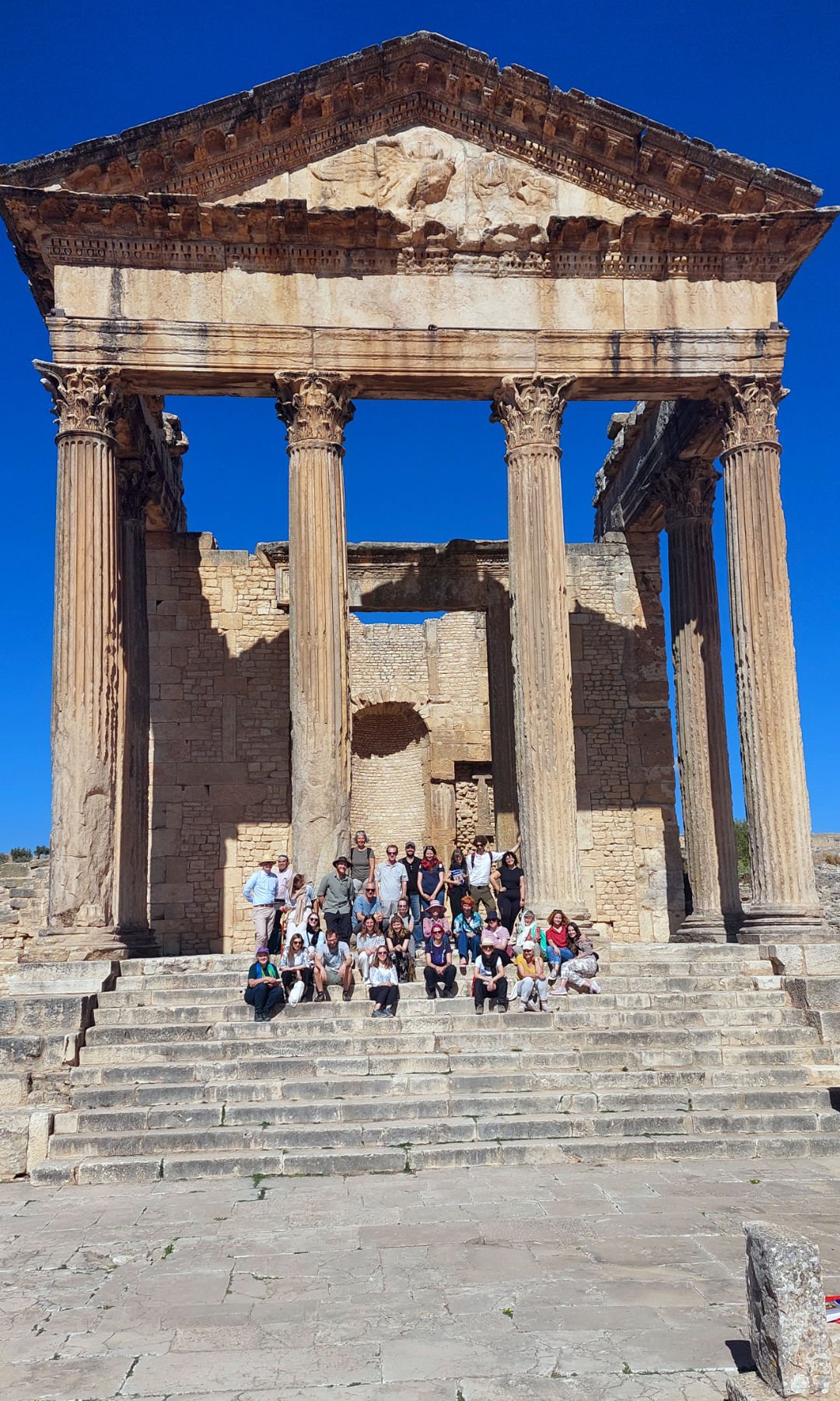 Auf den Stufen des nahezu vollständig erhaltenen Kapitolstempels der antiken Stadt Thugga