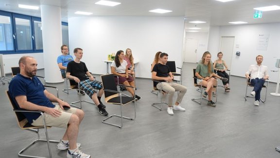 People sitting in chairs in a large room