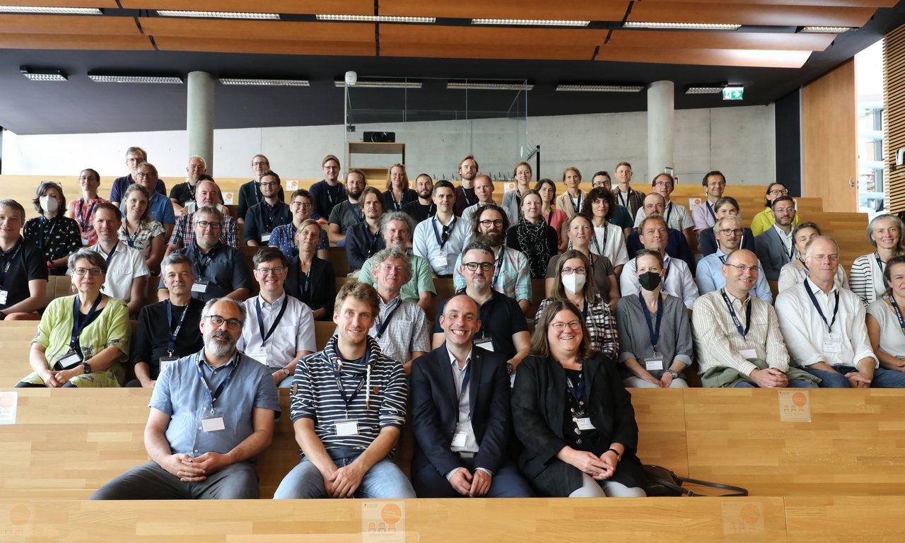People sitting on steps in an auditorium