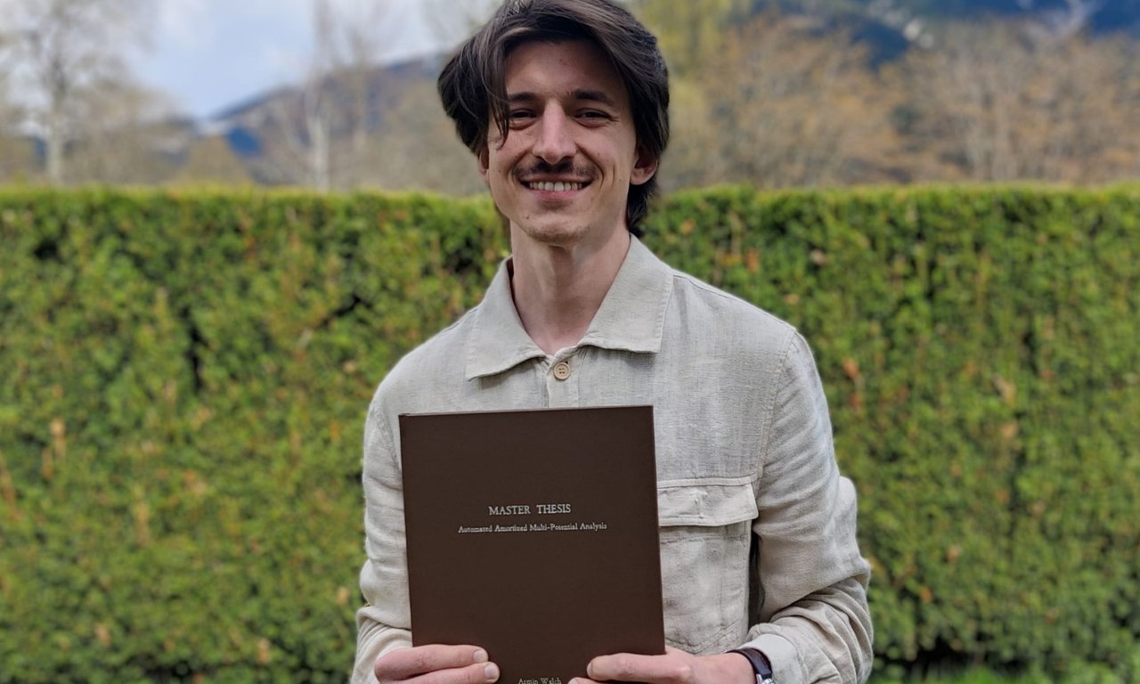 Armin Walch holding his Master's Thesis